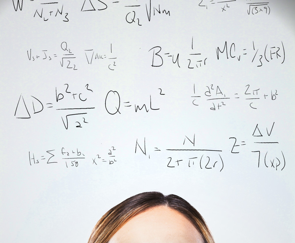 Woman looking up at equations